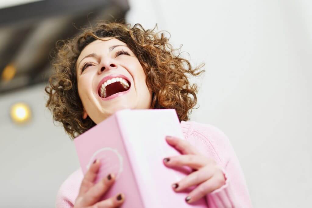 Woman Laughing With Book