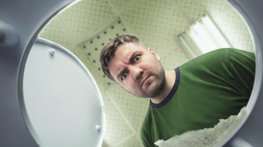 Man Looking Into Toilet