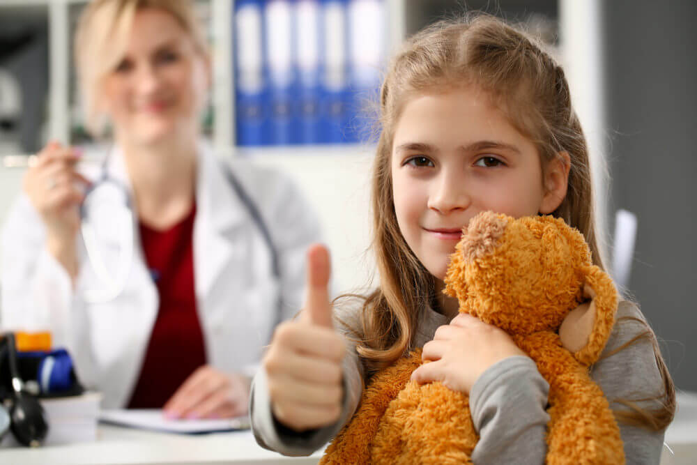 Happy little child girl hold teddy bear