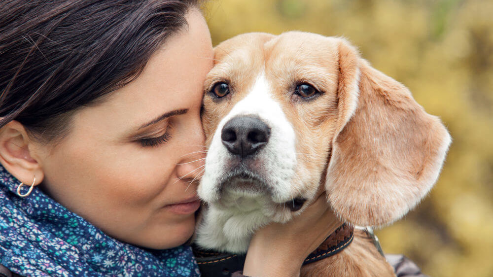 Woman hugging dog