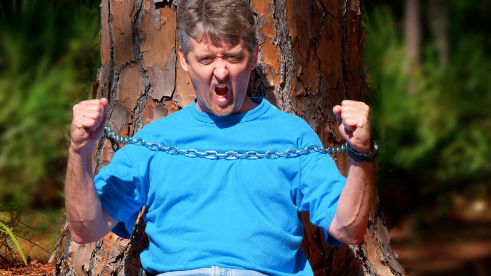 Environmentalist chained to tree