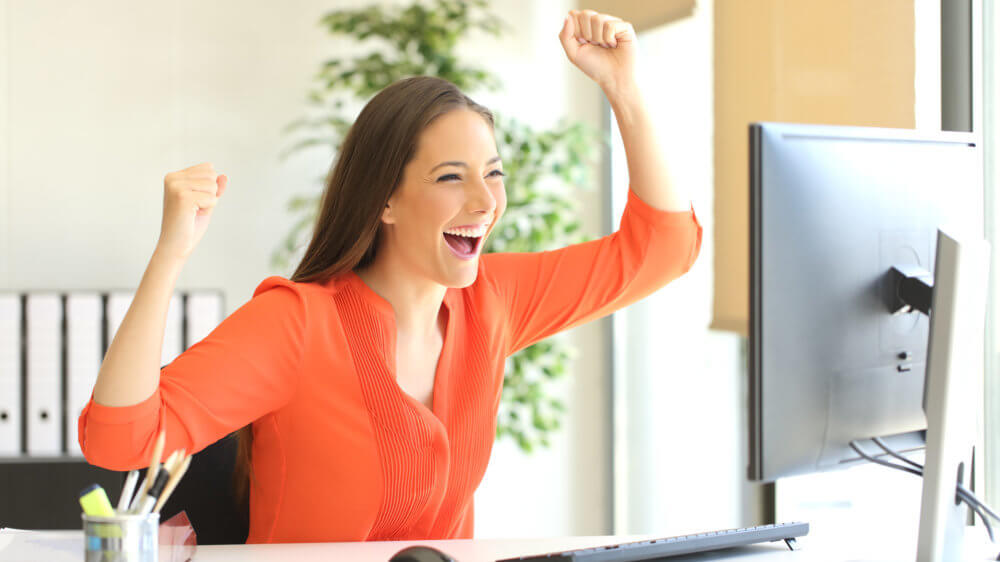 Excited woman at computer