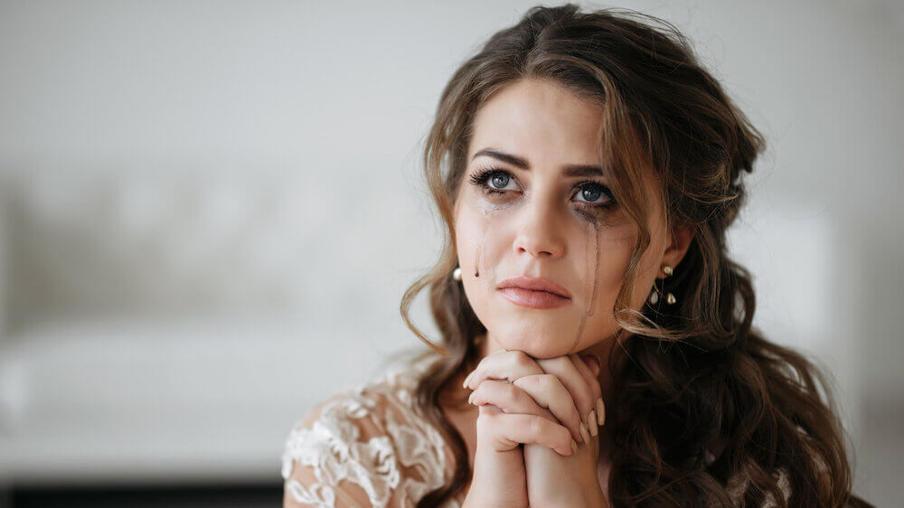 Woman crying in wedding dress