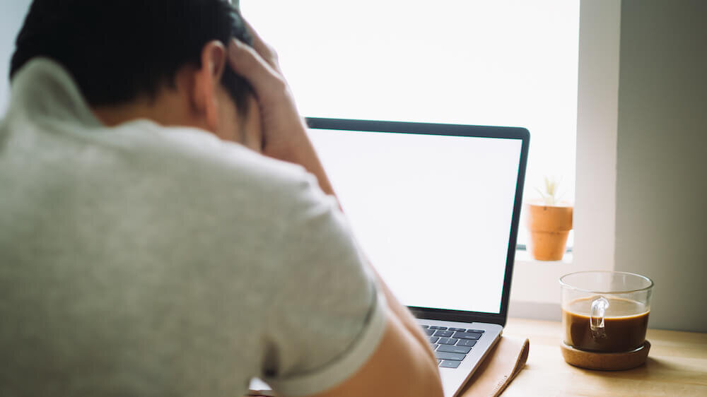 Frustrated man at laptop