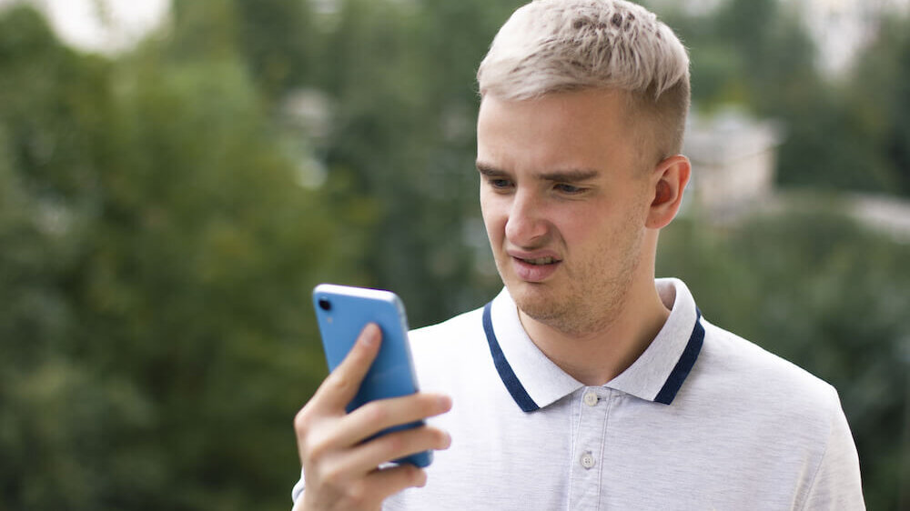 Guy frowning at phone