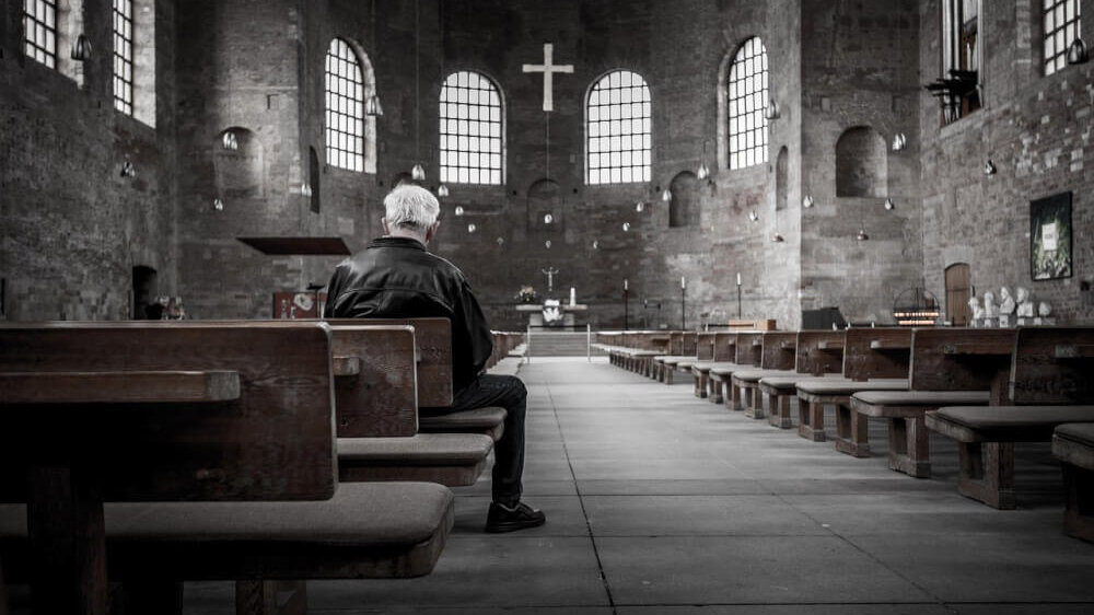 Man Praying in Church