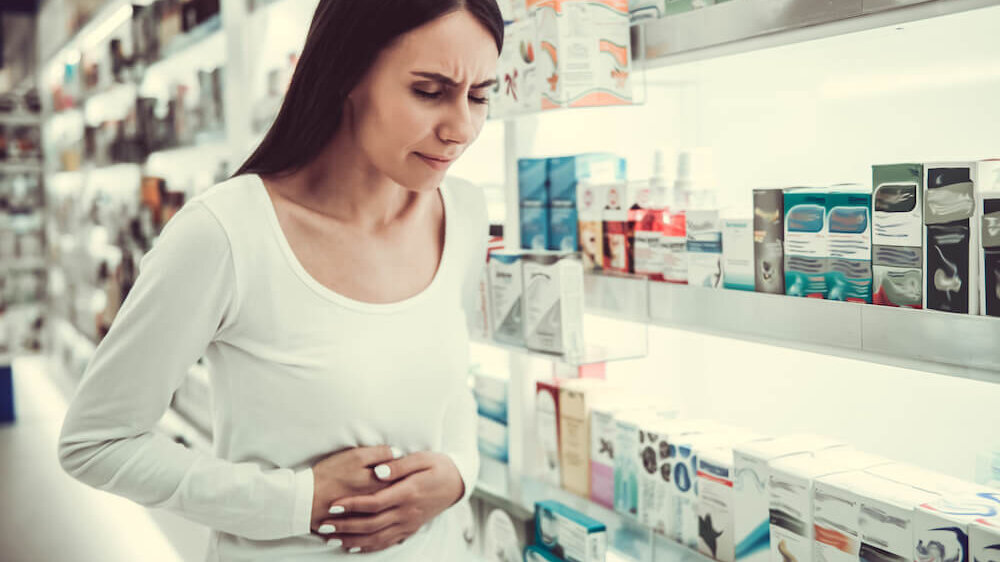 Woman at store with stomach pain