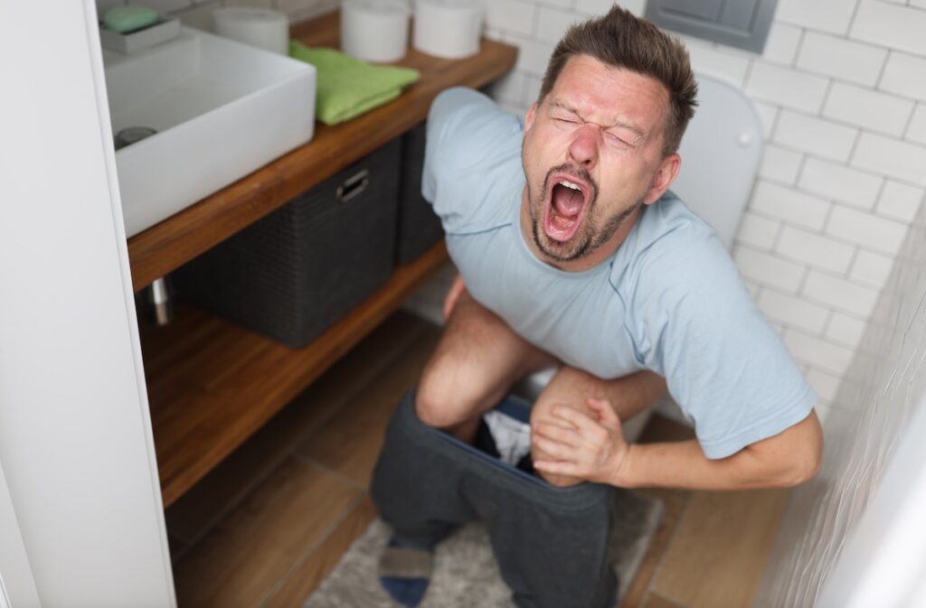 Man in pain on toilet
